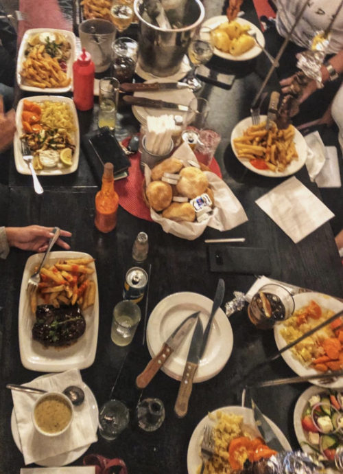 Flame-grilled peri-peri chicken plated with sides at Vasco's